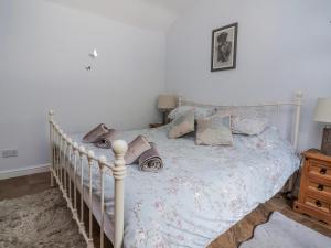 a bedroom with a white bed with pillows on it at Riverlea in Rhyl