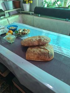 two loaves of bread sitting on a table at Miyar Farmhouse in Ak-Say