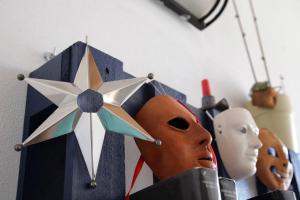 a group of masks and a star on a wall at Spapparra B&B in Càbras