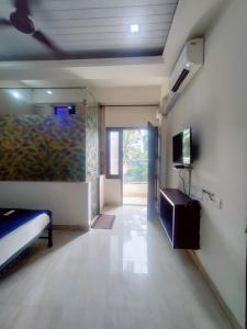 a room with a bed and a painting on the wall at Hotel bright house in Calangute