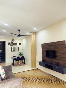 a living room with a flat screen tv on a wall at Teratak Raya in Tanjung Rambutan +1 photo