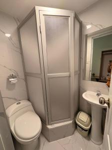 a white bathroom with a toilet and a sink at Hotel Altara AQP in Arequipa +58 photos