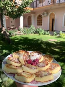 a plate of food on a table in front of a house at Guest House Shakuri in Samarkand