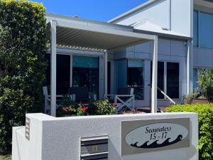 a sign in front of a house with at Keith's on Sylvan Beach, 1 of the 3 most popular units on Bribie in Bellara