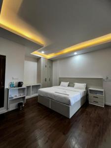 a bedroom with a large bed and a television at The View Hotel Falkland in Āīzawl +24 photos