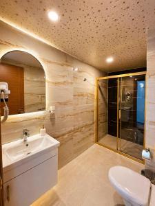 a bathroom with a sink and a shower at Britannia Hotel in Kemer