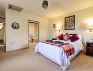 a bedroom with a bed and a clock on the wall at Pandy Barn Berriew in Welshpool