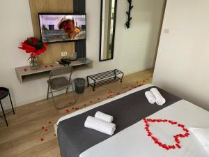 a bedroom with a bed with red rose petals on the floor at Hotel Unirea in Mamaia +48 photos