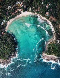 an aerial view of a beach with turquoise water at brun & browns in Matara