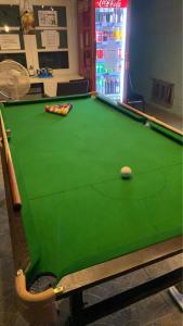 a pool table with a ball on top of it at Green Garden Hostel in Bangkok +36 photos