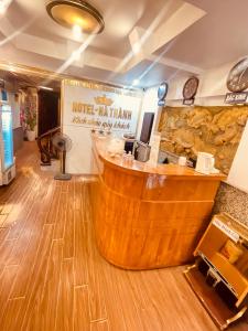a coffee shop with a wooden bar in a room at Hà Thành Luxury Hotel in Hanoi