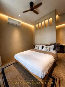 a bedroom with a large bed with a ceiling fan at CASA Ohana Private Villa in Thai Muang +11 photos