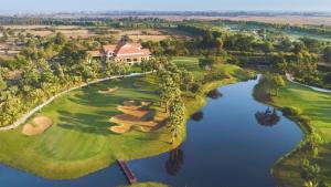 an aerial view of a golf course with a lake at Okay 1 Villa in Siem Reap