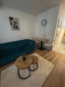 a living room with a green couch and a table at Apartmán JT in Vyšné Opátske