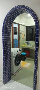 a blue tile archway with a washing machine in a bathroom at Hot Spring Residential B in Kuala Lumpur