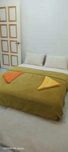 a large bed with two pillows on top of it at Hot Spring Residential B in Kuala Lumpur +5 photos