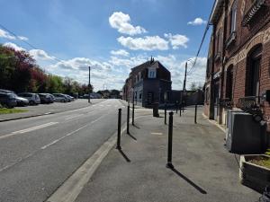 a street with a row of poles on the side of a road at appartement de madame de souter in Sequedin