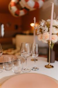 a group of wine glasses on a table with flowers at La Pimenta - SPA privatif & expérience immersive in Dole