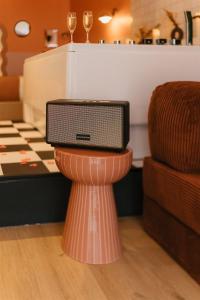 a television sitting on top of a stand in a room at La Pimenta - SPA privatif & expérience immersive in Dole