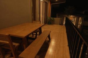 a wooden table and bench in a room at Layag La Union in san juan la union