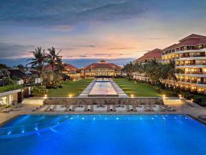 an exterior view of a resort with a swimming pool at Pullman Danang Beach Resort in Danang