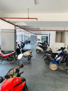 a group of motorcycles parked in a garage at Hotel The World in Surat +1 photo