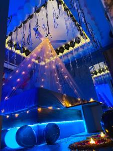 a bunch of lights hanging from a ceiling at Hotel The World in Surat