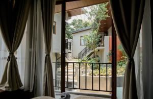 a room with a door open to a balcony at Layag La Union in san juan la union