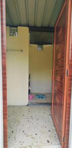 an open door to a room with a bathroom at Canopy Haven in Siliguri