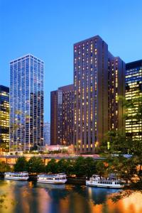 a city skyline with tall buildings and boats in the water at Hyatt Regency Chicago in Chicago