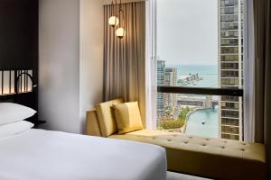 a hotel room with a bed and a large window at Hyatt Regency Chicago in Chicago +180 photos