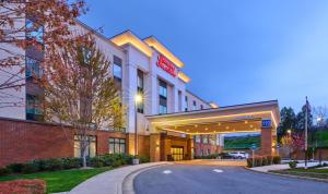 a rendering of a hotel building with a parking garage at Hampton Inn & Suites Grants Pass in Grants Pass
