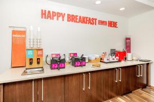 a kitchen counter with a happy breakfast zone sign on the wall at Hampton Inn & Suites Grants Pass in Grants Pass