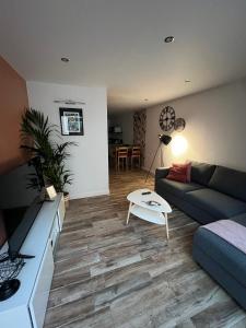 a living room with a couch and a table at Sylina Spa avec Jacuzzi Privé in Villeblevin