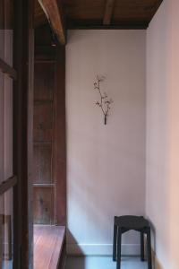 a room with a chair and a vase on the wall at new tradition hotel kanazawa in Kanazawa
