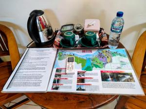 a table with a map and bottles of water on it at Kaia Lovina Guest House in Lovina +73 photos