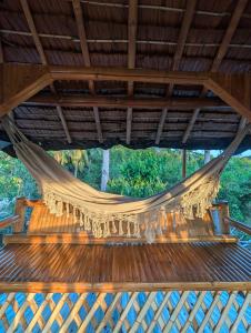 a hammock hanging from a wooden roof at Jadens Guesthouse in Siquijor