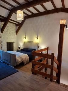 a bedroom with a large bed and a wooden railing at Gite des arches in Saint-Nectaire +17 photos