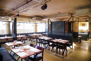 a restaurant with tables and chairs in a room at Tree Inn Jubilee in Hyderabad