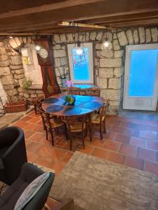 a dining room with a wooden table and chairs at Gite des arches in Saint-Nectaire