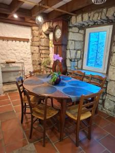 a dining room with a wooden table and chairs at Gite des arches in Saint-Nectaire