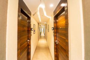 a hallway with wooden doors and a long corridor at Treebo Calangute Beach Stay in Calangute