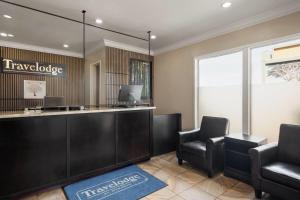 a lobby with two chairs and a reception desk at Travelodge by Wyndham Eureka in Eureka