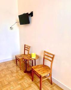 a table and two chairs and a table and a tv at Hotel Minh Phát in Công Thanh