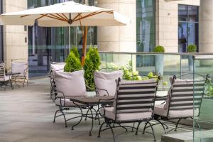 a group of chairs and an umbrella on a patio at Hilton Kyiv in Kyiv