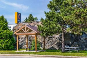 a gazebo in a park with two benches at Comfort Inn Sudbury East in Sudbury