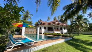 a villa with a swimming pool and a house at Tha sala beach house in Ban Phang Pling