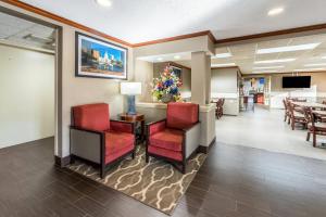a waiting room with red chairs and a table at Comfort Inn Festus-St Louis South in Festus
