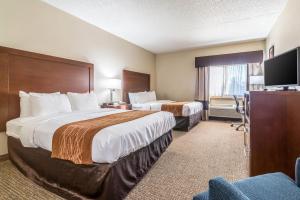 a hotel room with two beds and a flat screen tv at Comfort Inn Festus-St Louis South in Festus