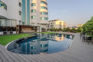 a swimming pool in front of a building at Happihaus Hotel Bangkok in Bangkok +17 photos